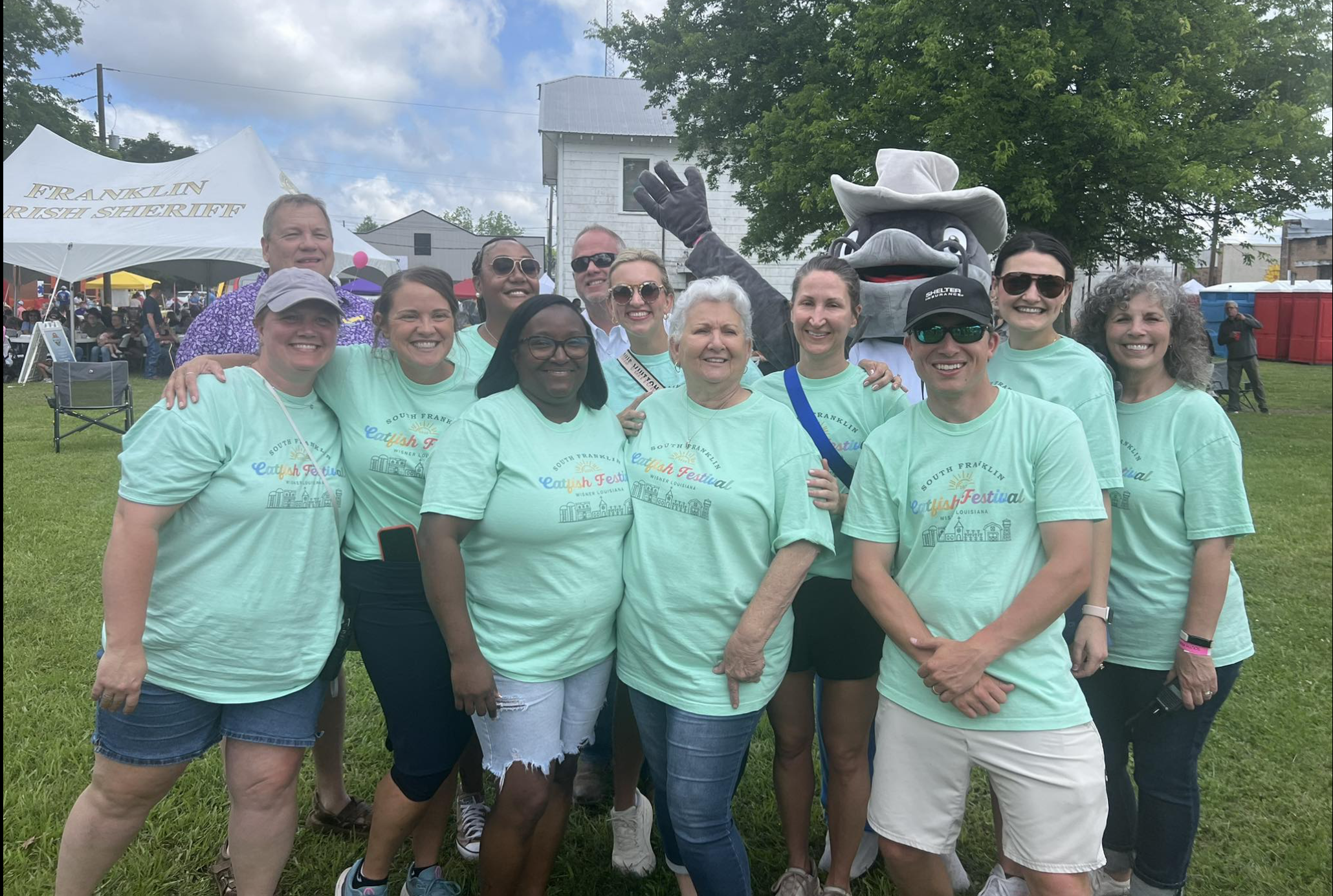 Festival volunteer crew with the catfish mascot